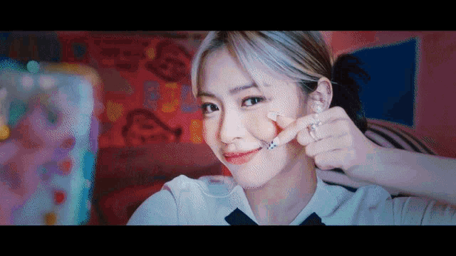 a woman is making a funny face with her finger