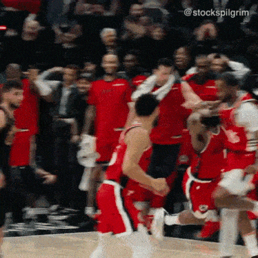 a basketball player in a red jersey with the number 1 on it runs towards a crowd