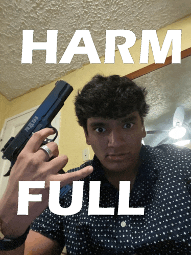 a man is holding a gun in front of a sign that reads harm full
