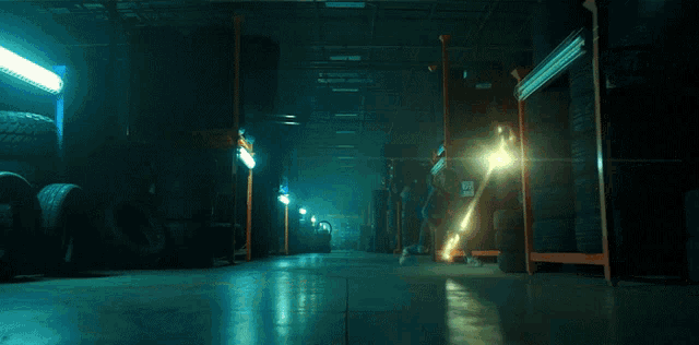 a tire is being thrown in the air in a warehouse