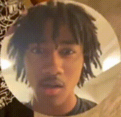 a close up of a man 's face with dreadlocks in a circle