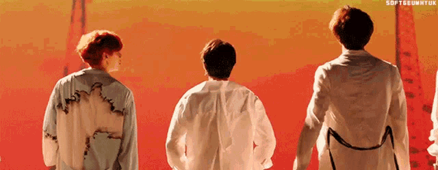 three men in white shirts are standing next to each other in front of a red background with the hashtag softseunhyunk