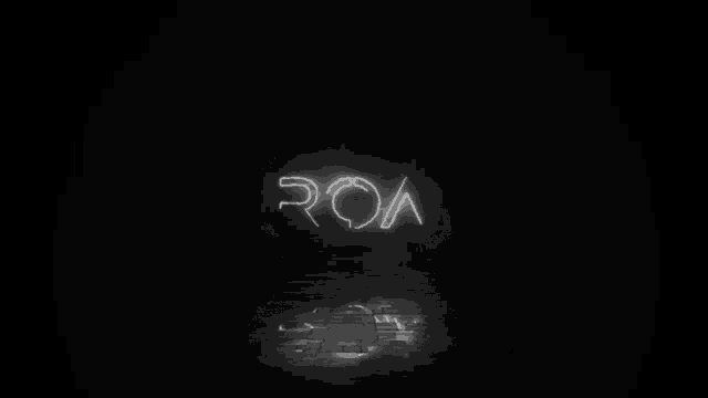 a neon sign that says roa in a dark room