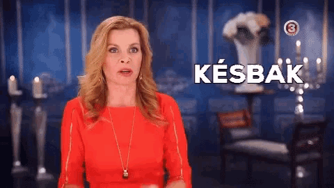 a woman in a red dress is standing in front of a sign that says kesbak ..