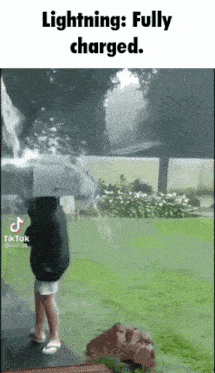 a person is standing in front of a waterfall with lightning coming from it