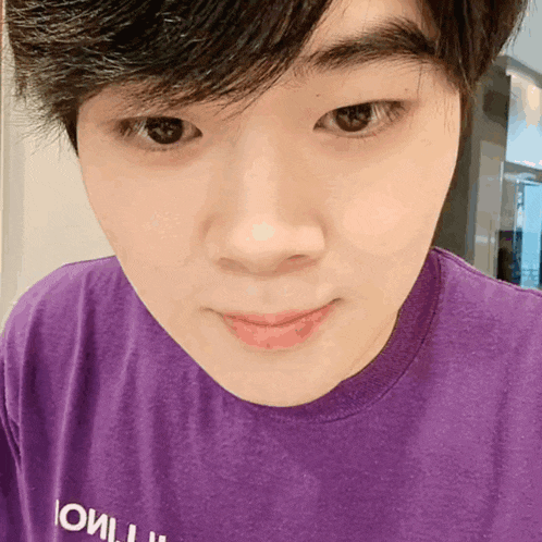 a close up of a person wearing a purple shirt that says ' i will ' on it