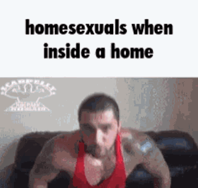 a man in a red tank top is doing push ups in a living room .