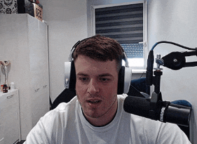 a man is wearing headphones and a shure microphone