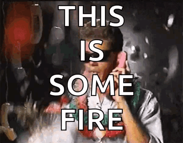 a man talking on a cell phone with the words " this is some fire " behind him