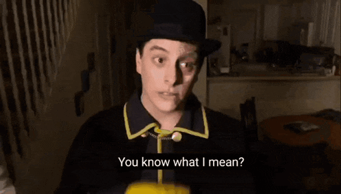 a man in a joker costume is pointing at the camera and says you know what i mean