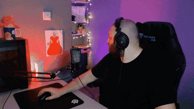 a man wearing headphones sits in a secret lab gaming chair