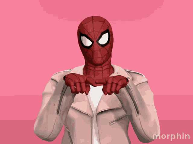 a person in a spiderman costume is making a peace sign