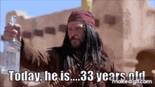 a man in a pirate costume is holding a bottle of liquor and saying `` today he is 33 years old '' .