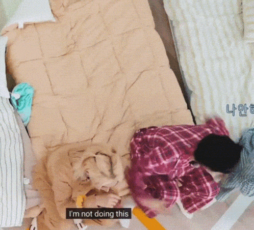 a person laying on a bed with the words " i 'm not doing this " written on the bottom