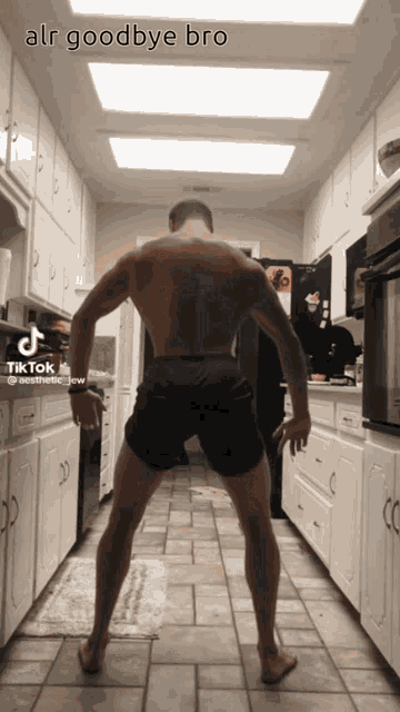 a man without a shirt is standing in a kitchen with the caption " alr goodbye bro " on the bottom