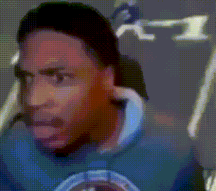a blurry picture of a man wearing a blue shirt with a picture of a bird on it .