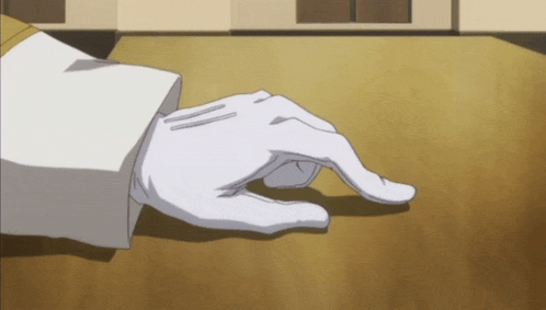 a person wearing a white glove is laying on a table