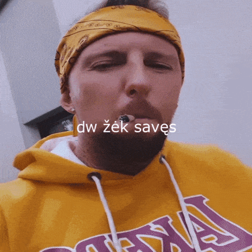 a man wearing a bandana and a yellow lakers hoodie
