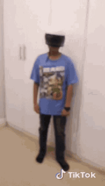 a person wearing a blue shirt that says tik tok