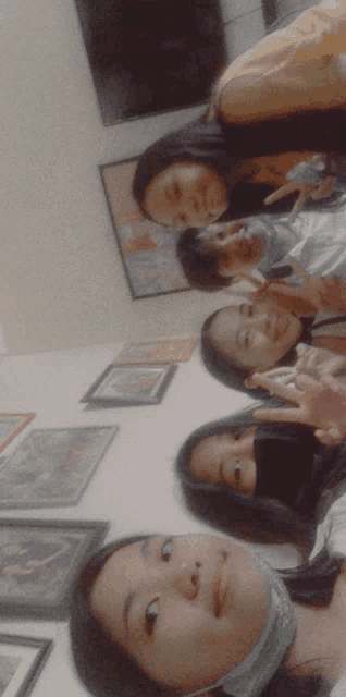 a group of girls are posing for a picture and one girl is wearing a face mask