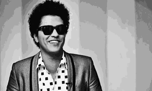 a black and white photo of a man wearing sunglasses and a jacket .
