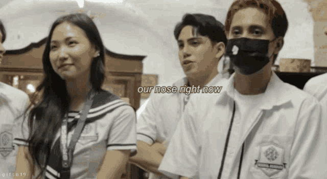 a group of people standing in a room with the words our nose right now written above them