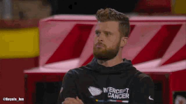 a man wearing a black shirt that says intercept cancer on it