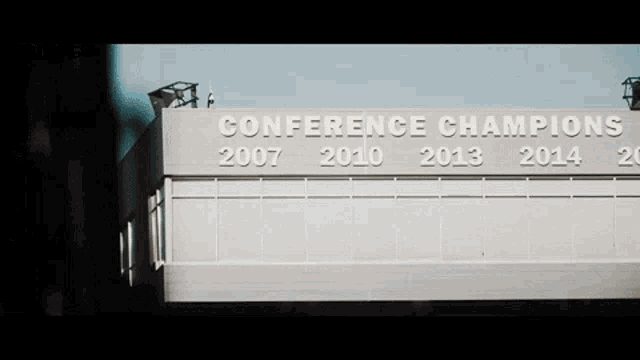 a sign on a building that says conference champions 2007 2010 2013 2014 2015