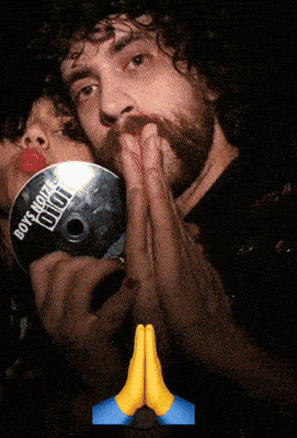 a man kisses a woman on the cheek while holding a cd that says " boys home "