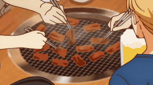 a group of people are grilling meat with chopsticks