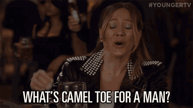 a woman in a leather jacket is asking what 's camel toe for a man .