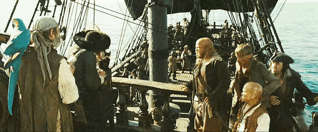 a group of pirates are standing on the deck of a boat