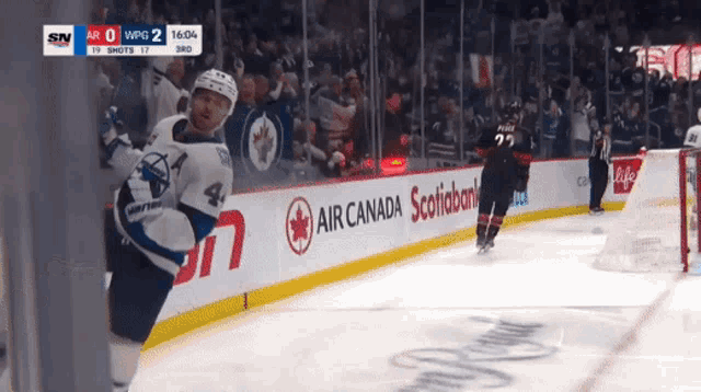 a hockey game is underway and air canada is one of the advertisers