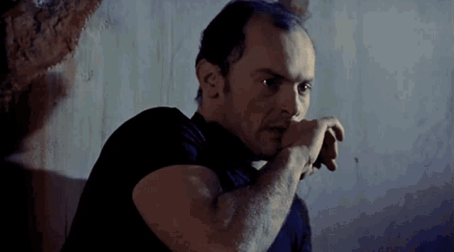 a man in a black shirt is looking at something