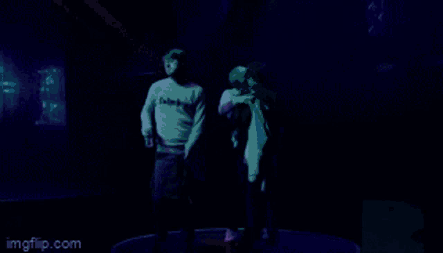a man and a woman are standing on a stage .