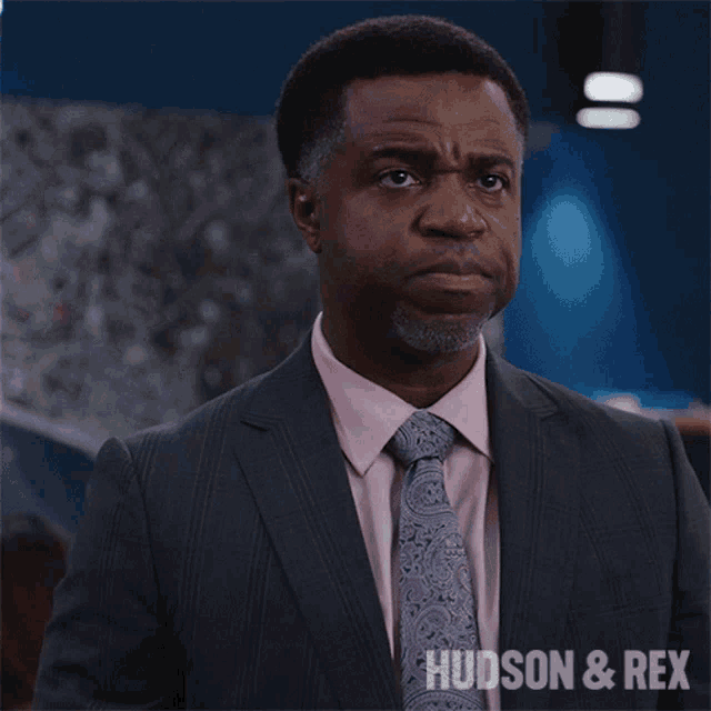 a picture of a man in a suit and tie with the caption " can we prove it "