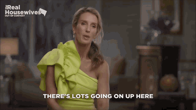 a woman in a neon green dress is talking about real housewives