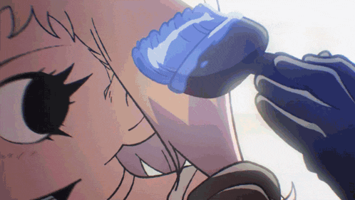 a close up of a person 's face with a blue brush on it