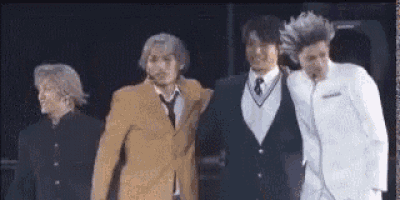 a group of young men are standing next to each other on a stage .