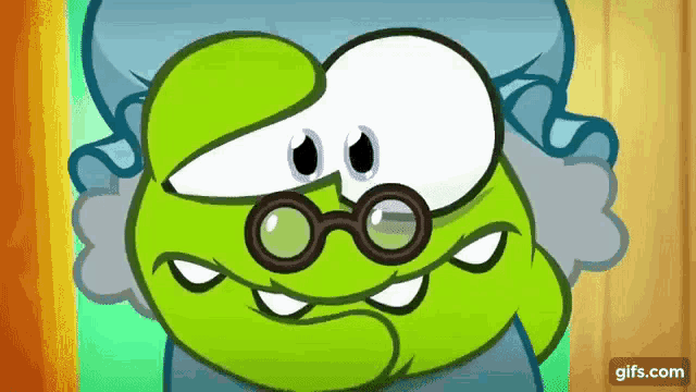 a green cartoon character wearing glasses and a hat is sitting on a bed .