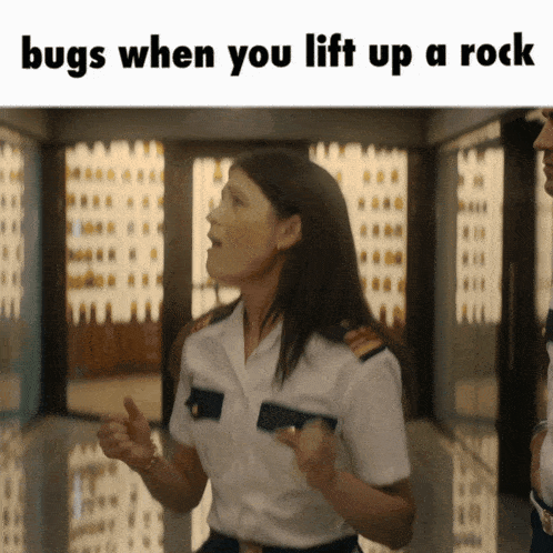 a woman in a military uniform says bugs when you lift up a rock while standing next to another woman