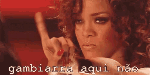 a woman with curly hair is making a funny face and pointing her finger .