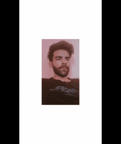a man with a beard is wearing a black shirt that says ciao on the bottom