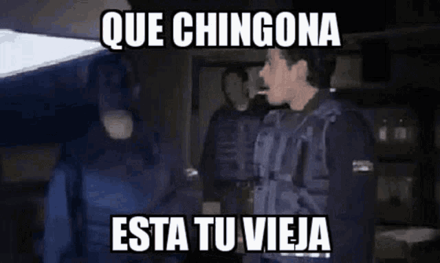 a police officer is talking to another police officer in a dark room with a caption that says que chingona esta tu viej