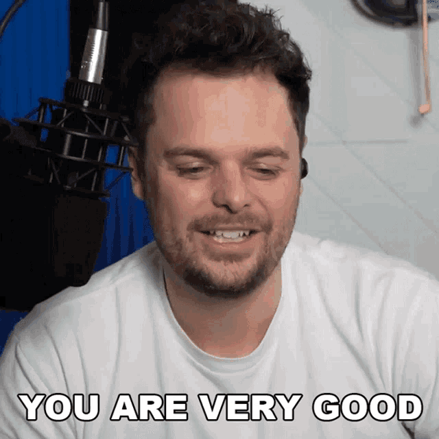 a man in a white shirt is smiling and says you are very good