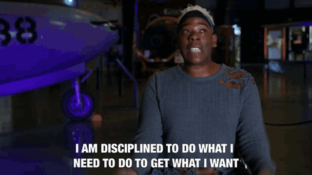 a man says i am disciplined to do what i need to do to get what i want in front of a plane