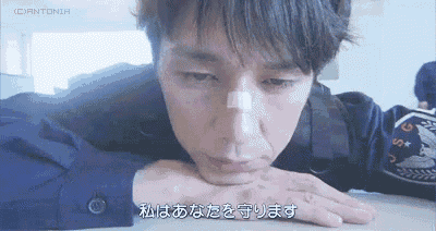 a man with a bandage on his nose is laying on a table