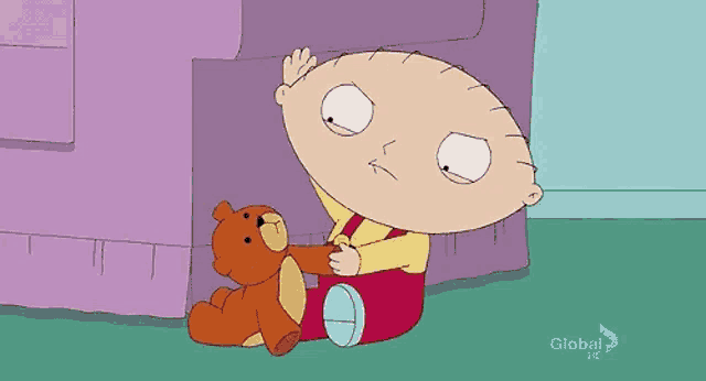a cartoon character is sitting on the floor with a teddy bear .