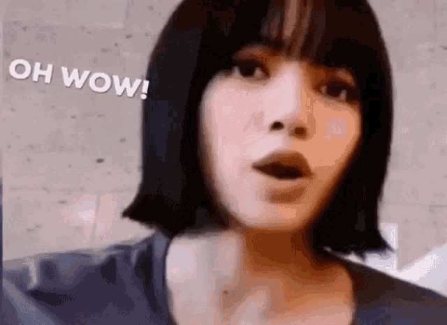 a close up of a woman 's face with a surprised look on her face and the words `` oh wow '' .