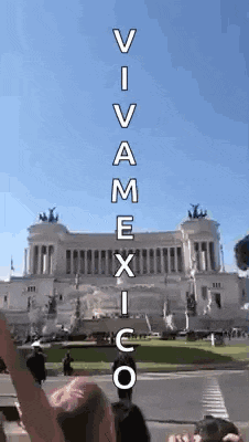 a man stands in front of a building with the words " viva mexico " written on it